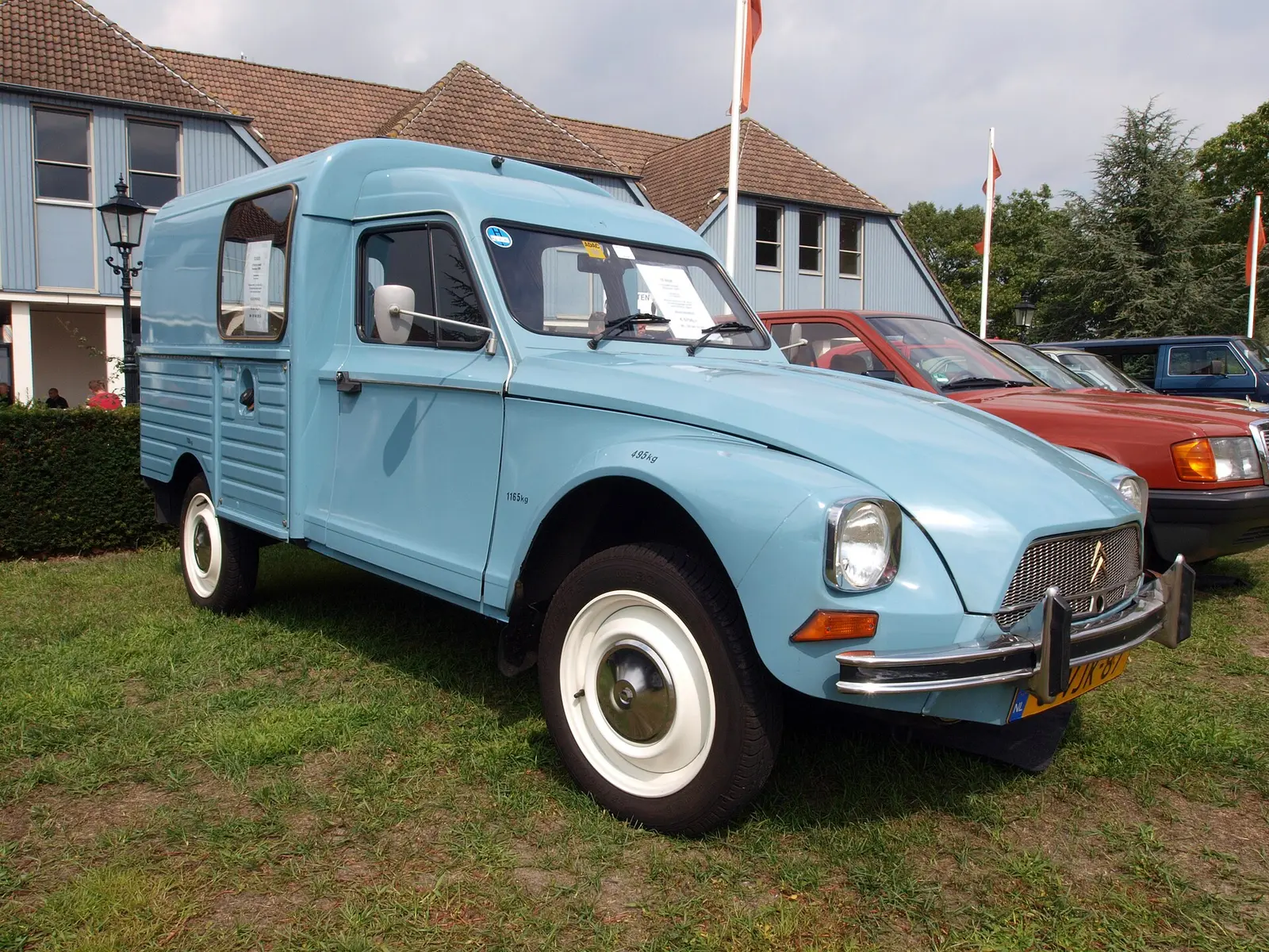 A pale blue Citroen Acadiane van on the lawn in front of the Autotron exhibition buildings in Rosmalen