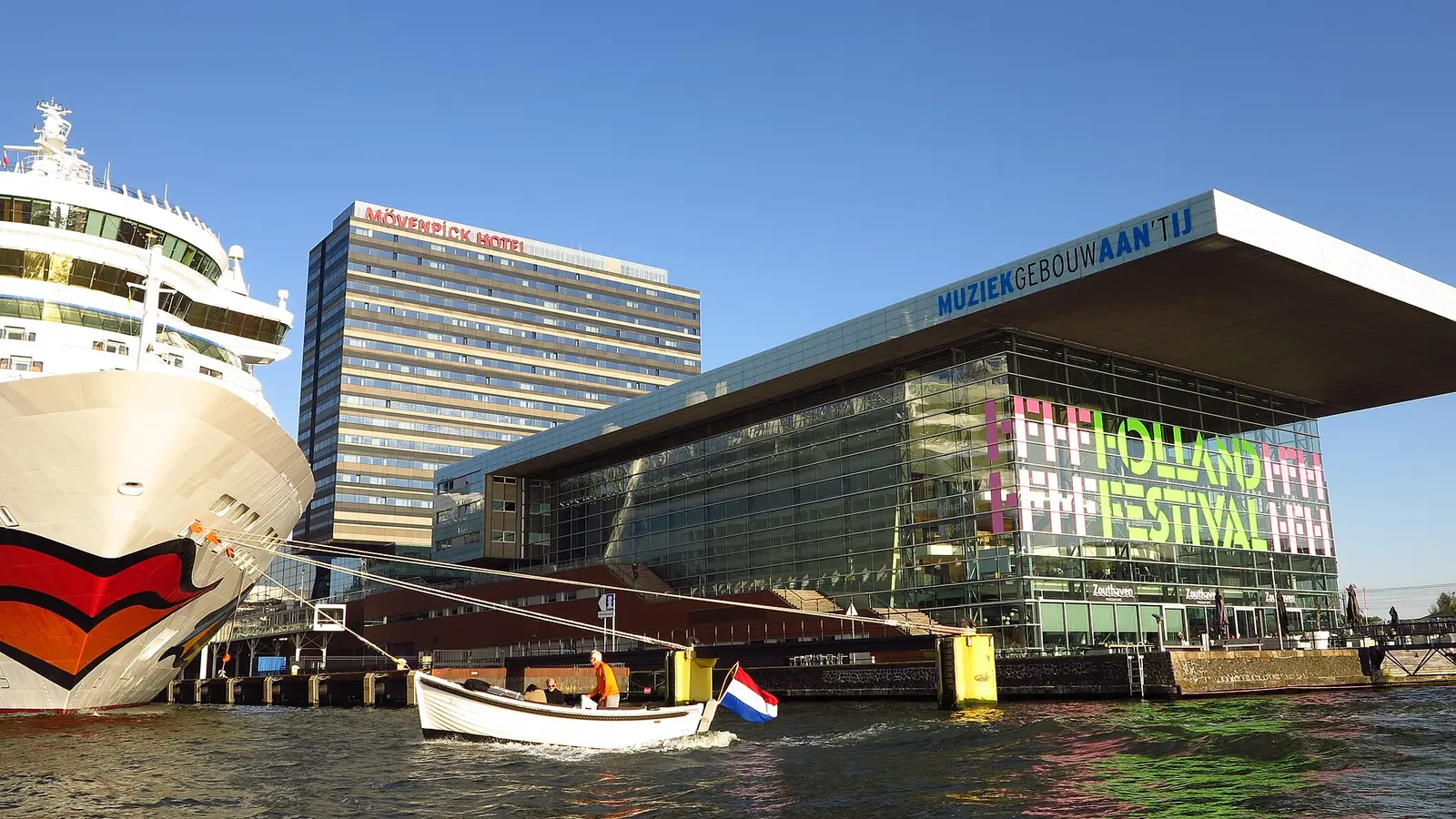 The Muziekgebouw aan 't IJ on the waterfront in Amsterdam with Holland Festival lettering on its glass facade