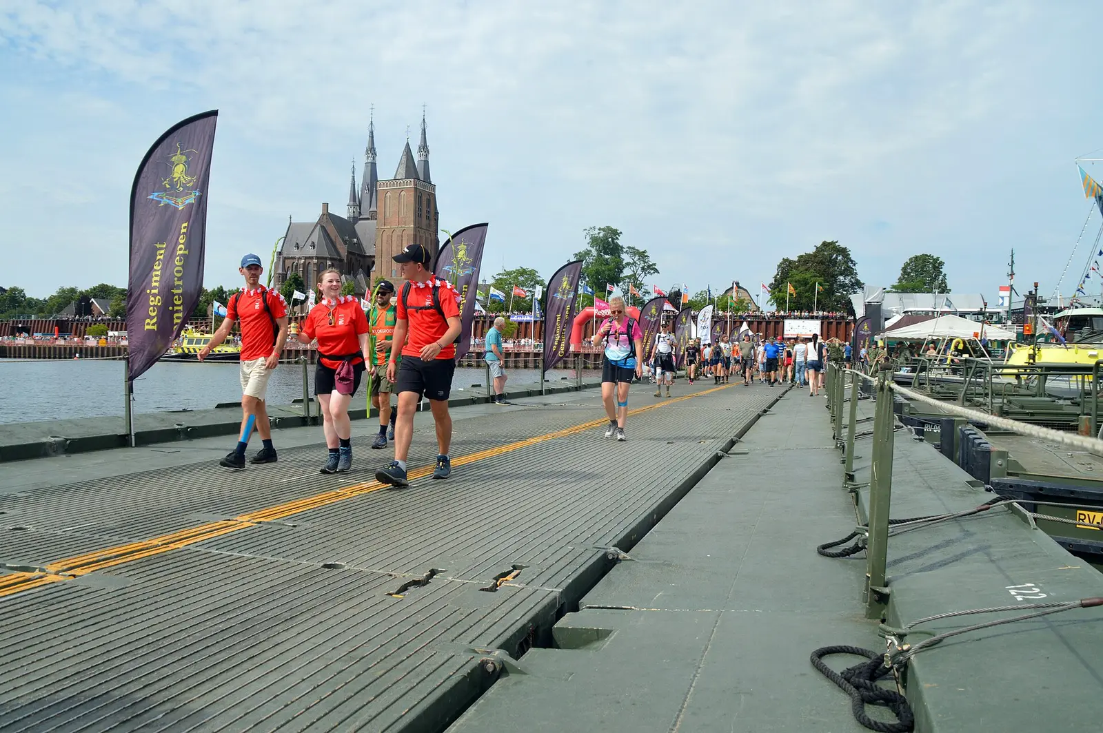Walkers crossing a pontoon bridge over the Maas during the Nijmegen Four Days Marches in 2024
