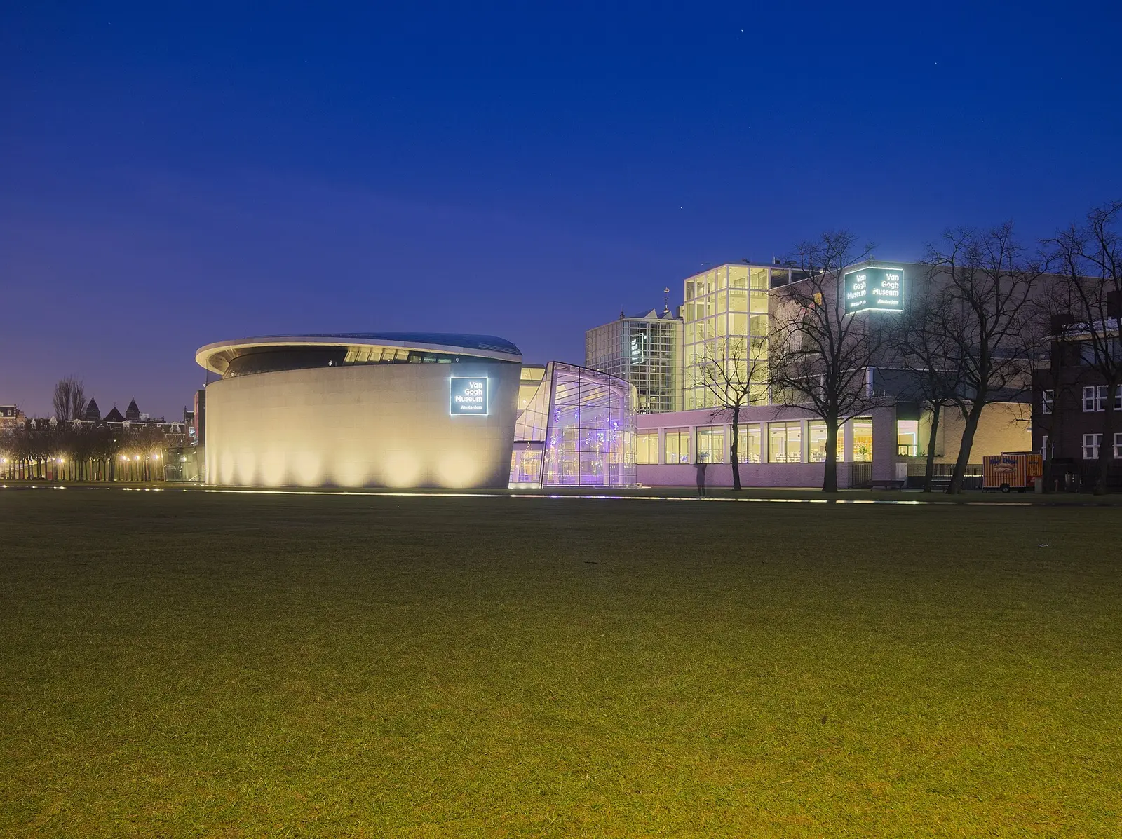 The Van Gogh Museum on Museumplein in Amsterdam at blue hour with the oval Kurokawa wing lit